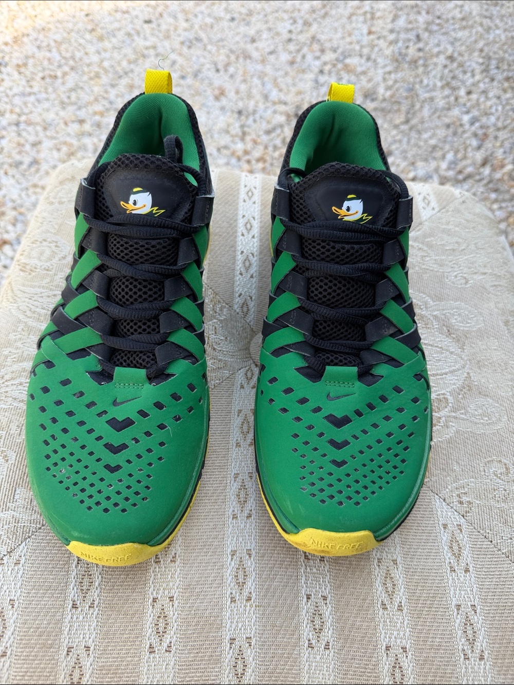 These are Nike Free Trainer 5.0 sneakers in the "Oregon Ducks" colorway